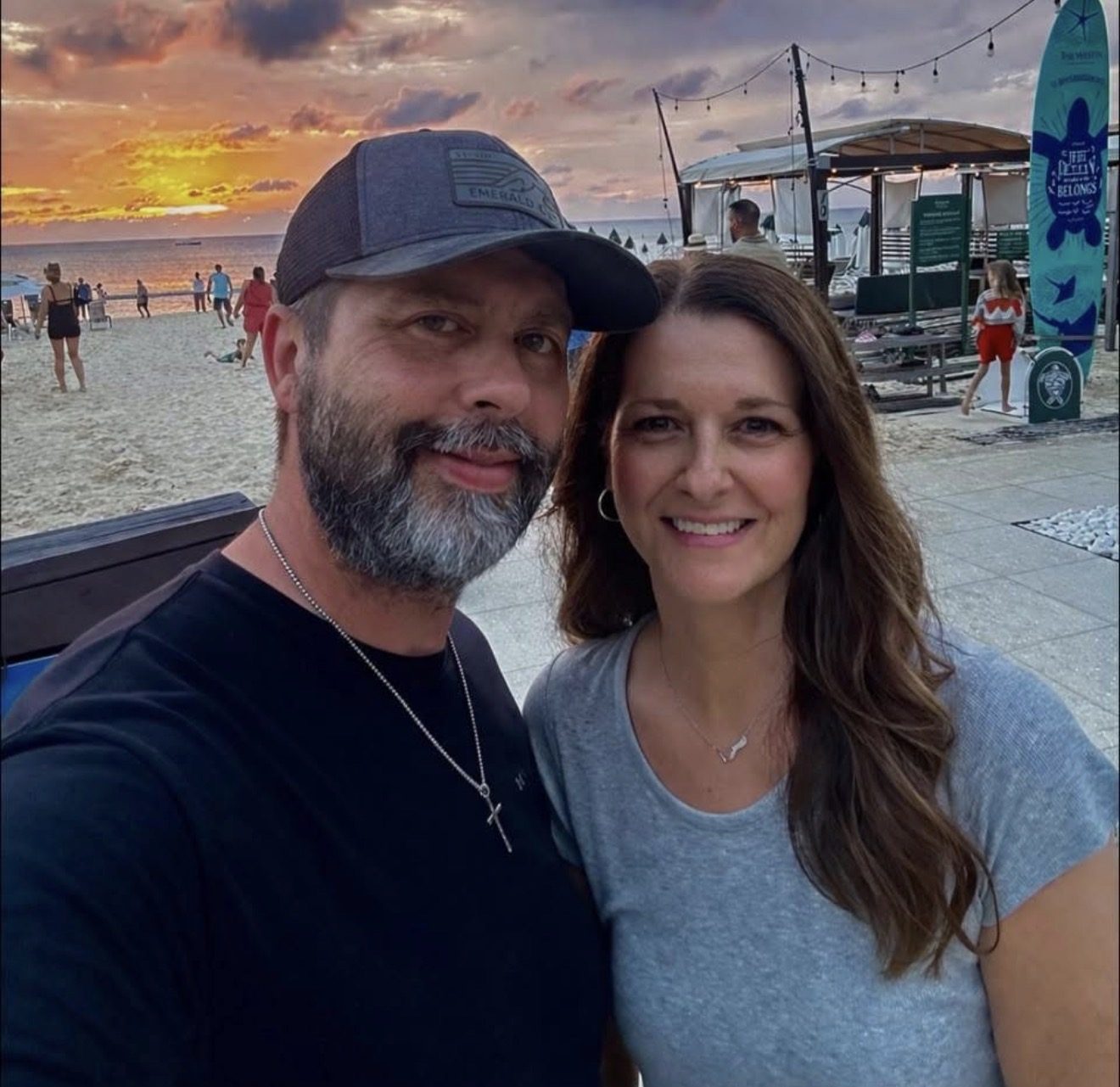 Matt and his wife at the beach near sunset