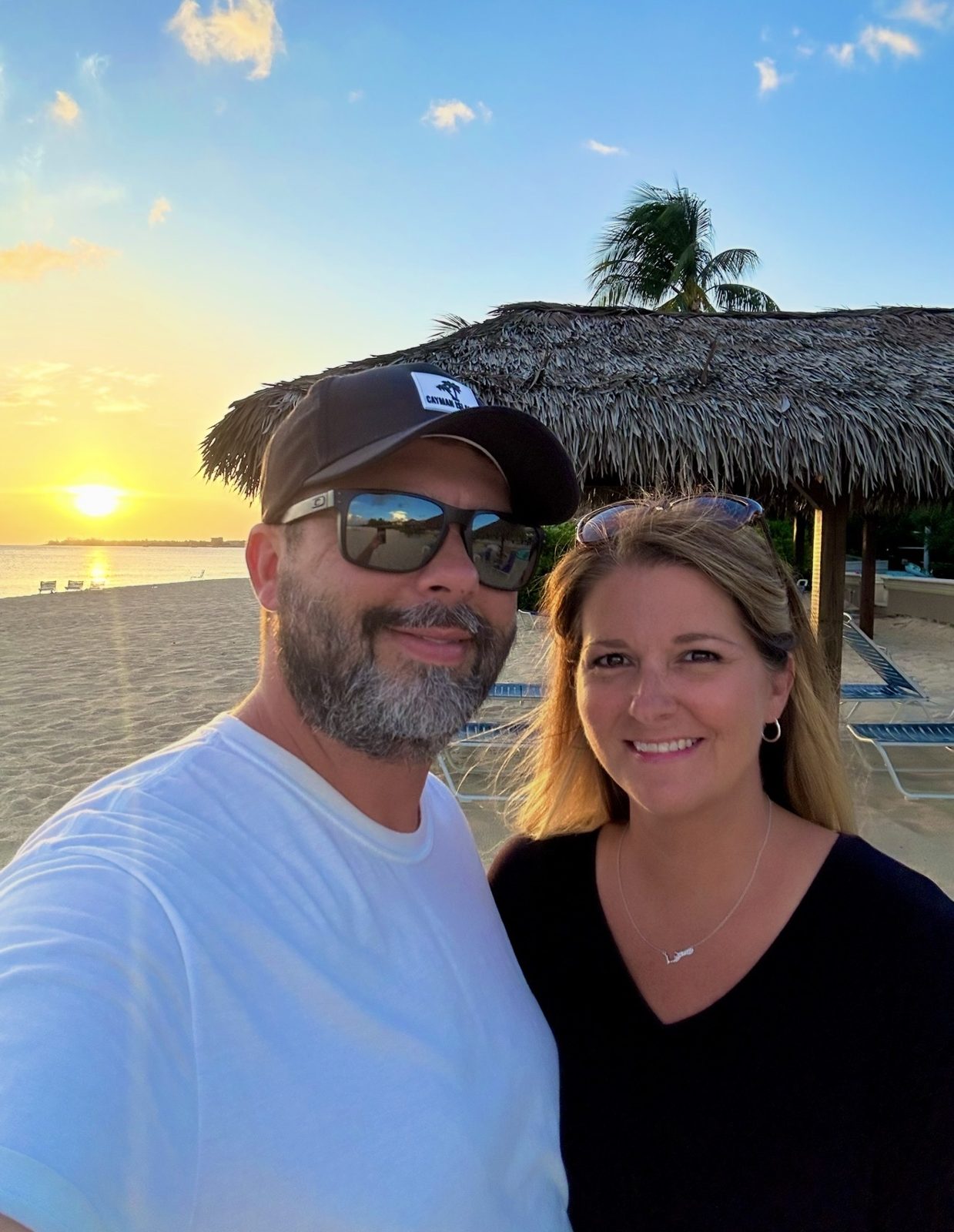 Matt and his wife in Cayman on the beach in Cayman at sunset