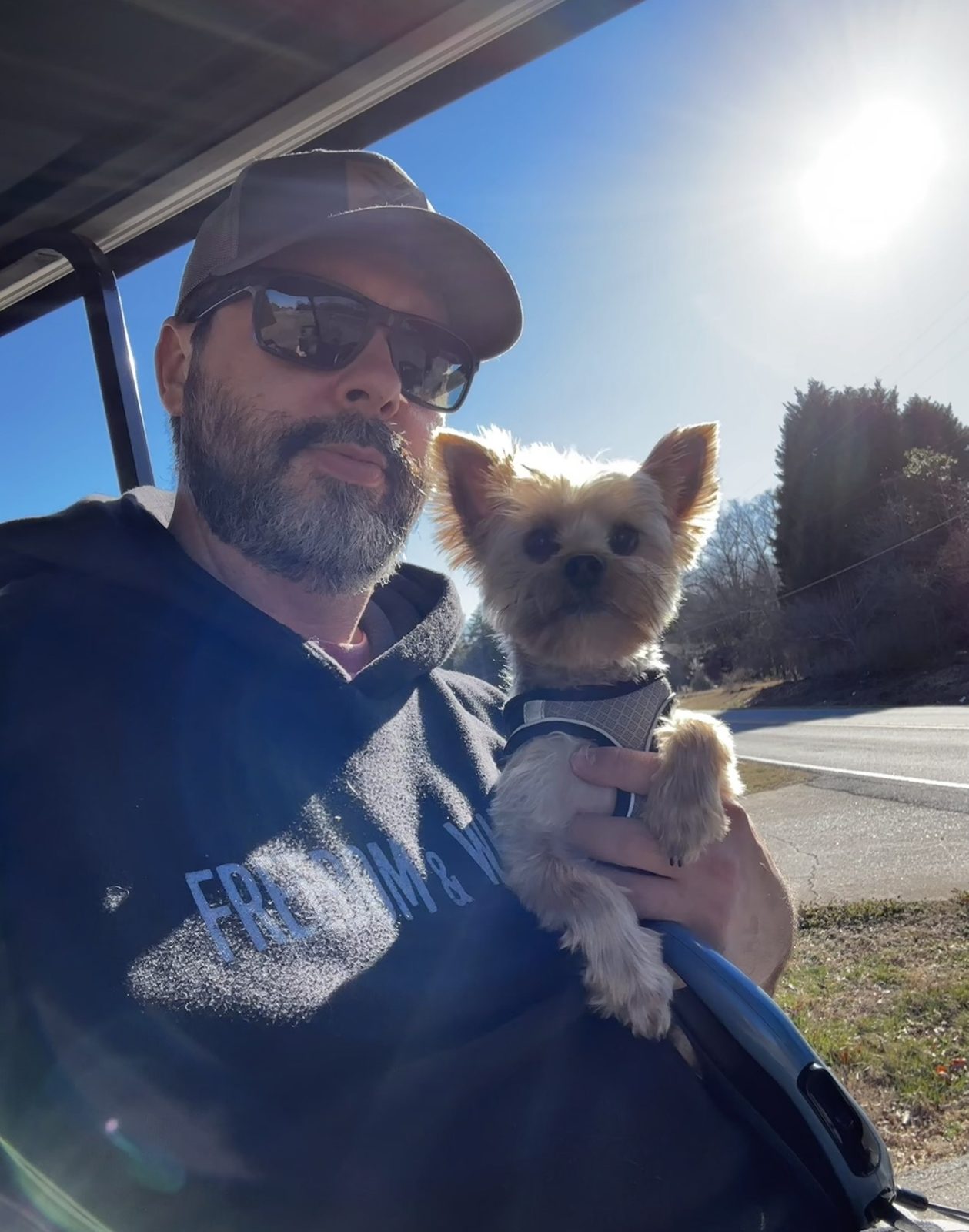 Matt enjoying a sunny day with his small dog